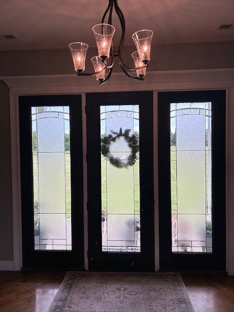 15172 S Henry Ln, Ashland, MO 65010 - foyer with healthy amount of natural light, a chandelier, and wood finished floors