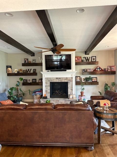 15172 S Henry Ln, Ashland, MO 65010 - living room with beamed ceiling, a ceiling fan, wood finished floors, and a stone fireplace