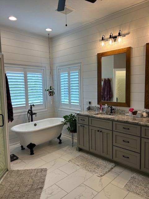 15172 S Henry Ln, Ashland, MO 65010 - full bathroom with marble look tile flooring, vanity, a freestanding tub, ornamental molding, and ceiling fan