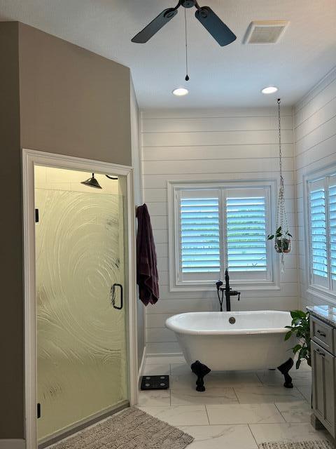 15172 S Henry Ln, Ashland, MO 65010 - full bath with ceiling fan, a freestanding tub, marble look tiles, vanity, and a shower stall