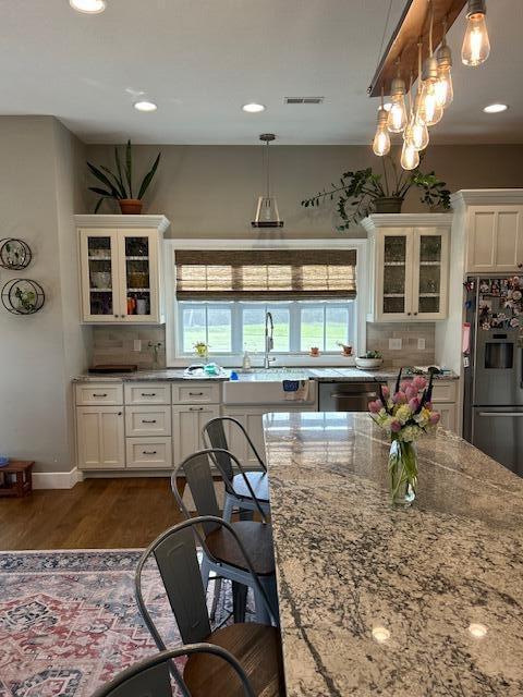 15172 S Henry Ln, Ashland, MO 65010 - kitchen with fridge with ice dispenser, dark wood-style flooring, light stone counters, backsplash, and recessed lighting