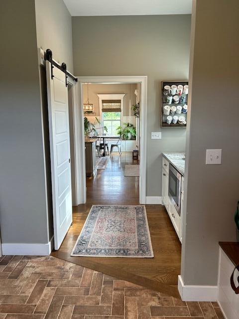 15172 S Henry Ln, Ashland, MO 65010 - corridor with a barn door and baseboards