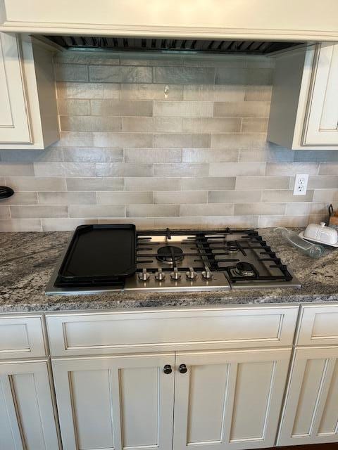 15172 S Henry Ln, Ashland, MO 65010 - kitchen with decorative backsplash, white cabinets, and dark stone counters