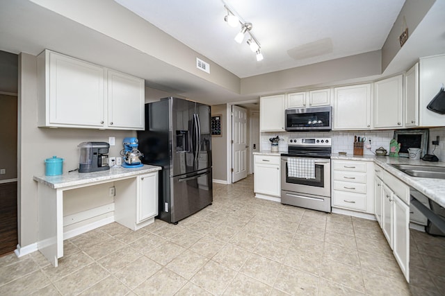 170 E Crest Ct, Columbia, MO 65202 - kitchen with stainless steel appliances, decorative backsplash, white cabinetry, and baseboards