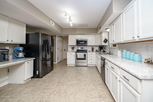 170 E Crest Ct, Columbia, MO 65202 - kitchen with appliances with stainless steel finishes, a sink, white cabinetry, decorative backsplash, and light tile patterned floors