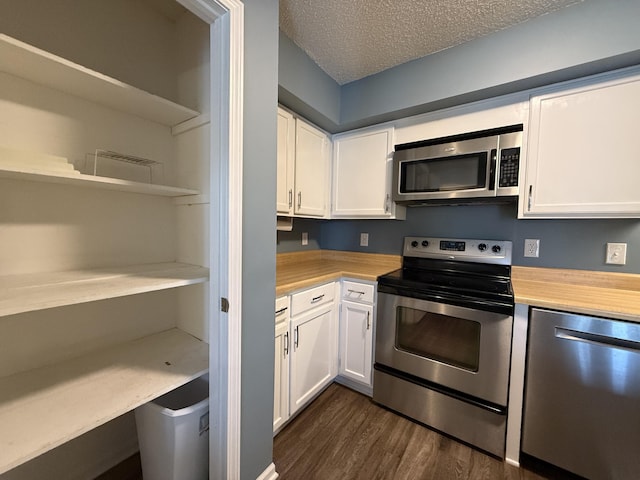 500 Columbia Dr Unit D, Columbia, MO 65203 - kitchen with stainless steel appliances, white cabinets, dark wood-style floors, a textured ceiling, and open shelves