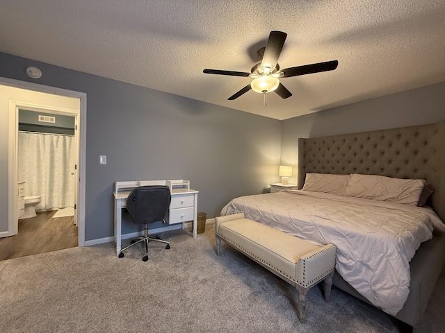 500 Columbia Dr Unit D, Columbia, MO 65203 - carpeted bedroom featuring a textured ceiling, a desk, a ceiling fan, and baseboards