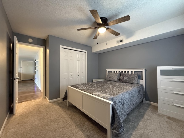 500 Columbia Dr Unit D, Columbia, MO 65203 - carpeted bedroom with a closet, baseboards, a textured ceiling, and a ceiling fan