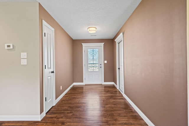 15620 Allegiance Ave, Ashland, MO 65010 - foyer entrance with dark wood finished floors, baseboards, and a textured ceiling