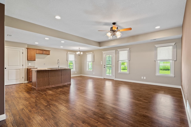 15620 Allegiance Ave, Ashland, MO 65010 - unfurnished living room with dark wood-style flooring, ceiling fan, baseboards, a sink, and recessed lighting