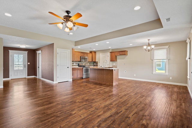 15620 Allegiance Ave, Ashland, MO 65010 - kitchen featuring open floor plan, stainless steel appliances, brown cabinets, a chandelier, and light countertops