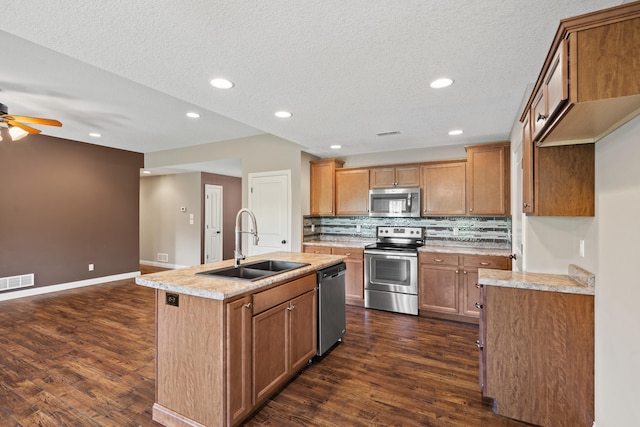 15620 Allegiance Ave, Ashland, MO 65010 - kitchen featuring appliances with stainless steel finishes, a sink, ceiling fan, dark wood-type flooring, and backsplash