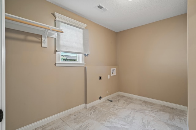 15620 Allegiance Ave, Ashland, MO 65010 - laundry area with hookup for an electric dryer, hookup for a washing machine, baseboards, marble finish flooring, and a textured ceiling