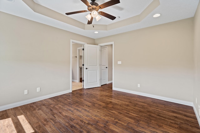 15620 Allegiance Ave, Ashland, MO 65010 - unfurnished room with a tray ceiling, a ceiling fan, baseboards, wood finished floors, and recessed lighting
