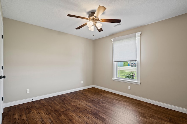 15620 Allegiance Ave, Ashland, MO 65010 - spare room with baseboards, dark wood-type flooring, a ceiling fan, and a textured ceiling