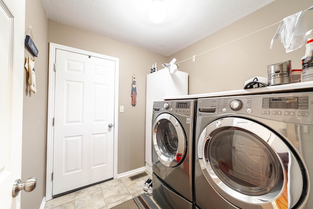 2803 Wooded Creek Dr, Columbia, MO 65203 - washroom featuring washer and dryer, baseboards, and a textured ceiling