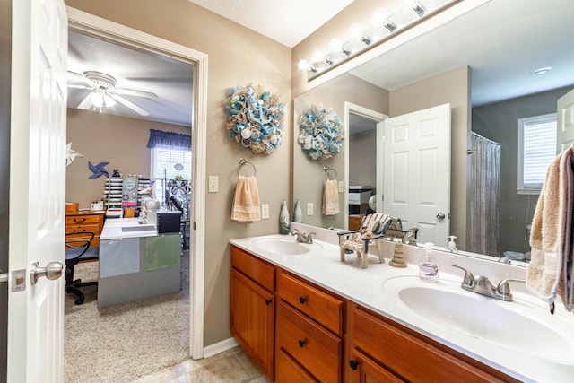 2803 Wooded Creek Dr, Columbia, MO 65203 - bathroom with plenty of natural light, double vanity, a ceiling fan, and baseboards