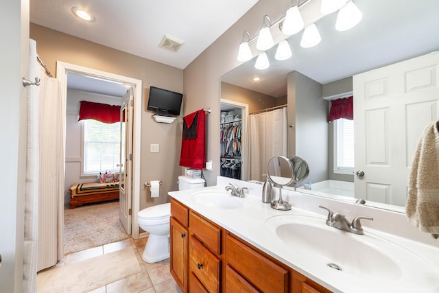 2803 Wooded Creek Dr, Columbia, MO 65203 - full bath with plenty of natural light, toilet, double vanity, and tile patterned flooring