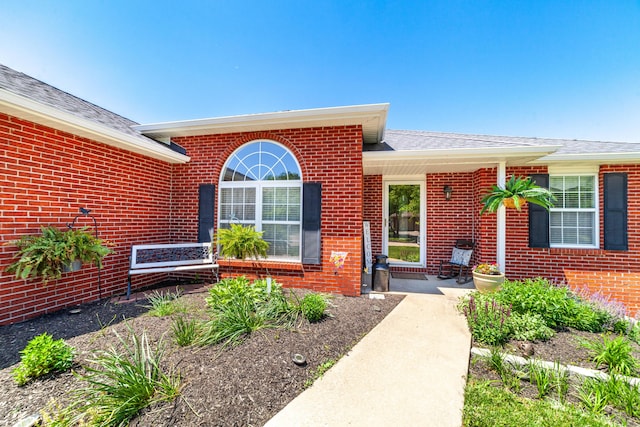 2803 Wooded Creek Dr, Columbia, MO 65203 - view of exterior entry featuring brick siding and roof with shingles