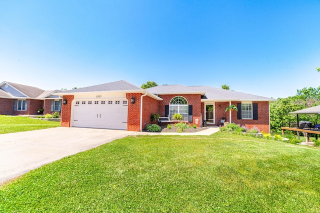 2803 Wooded Creek Dr, Columbia, MO 65203 - single story home with an attached garage, a front yard, brick siding, and driveway