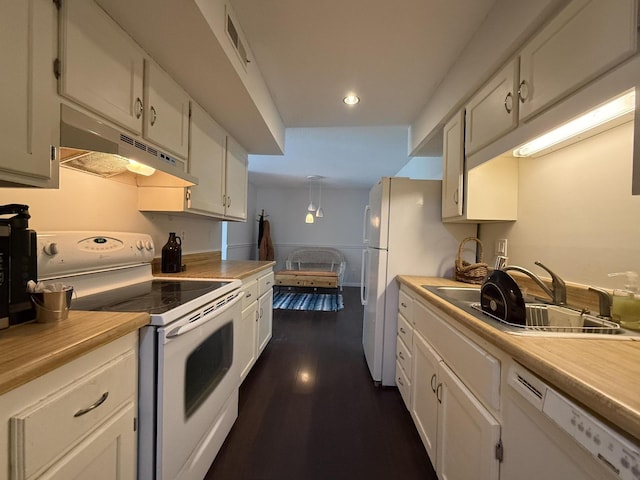 1999 N Waterfront Dr Unit H, Columbia, MO 65202 - kitchen featuring white appliances, under cabinet range hood, a sink, light countertops, and recessed lighting