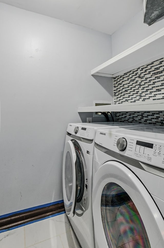 509 Columbia Dr Unit B, Columbia, MO 65201 - washroom with marble look tiles and washer and dryer