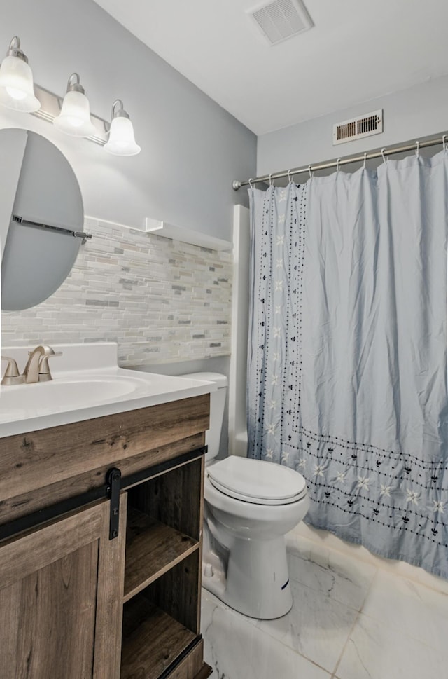 509 Columbia Dr Unit B, Columbia, MO 65201 - full bathroom featuring marble look tiles, vanity, toilet, backsplash, and curtained shower
