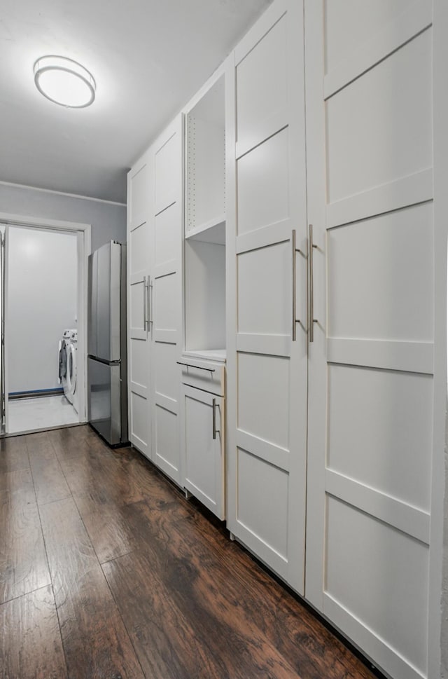 509 Columbia Dr Unit B, Columbia, MO 65201 - kitchen with freestanding refrigerator, dark wood-type flooring, washer / clothes dryer, and white cabinetry