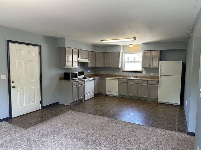 5451 S Bethel Church Rd Unit 3-301, Columbia, MO 65203 - kitchen featuring white appliances, a sink, under cabinet range hood, dark carpet, and dark tile patterned flooring