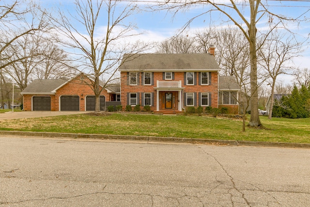 404 S Greenwood Ave, Columbia, MO 65203 - colonial house with driveway, brick siding, a chimney, and a front lawn