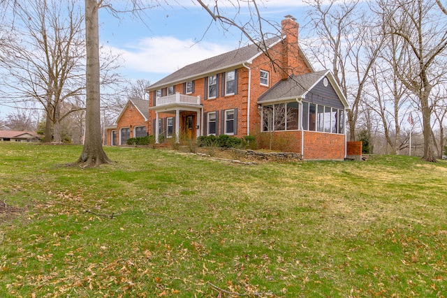 404 S Greenwood Ave, Columbia, MO 65203 - view of front facade featuring a balcony, brick siding, a sunroom, a chimney, and a front lawn