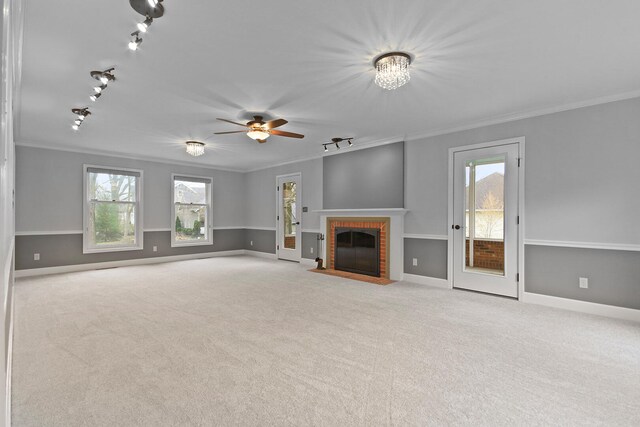 404 S Greenwood Ave, Columbia, MO 65203 - unfurnished living room featuring crown molding, track lighting, a fireplace, carpet flooring, and baseboards