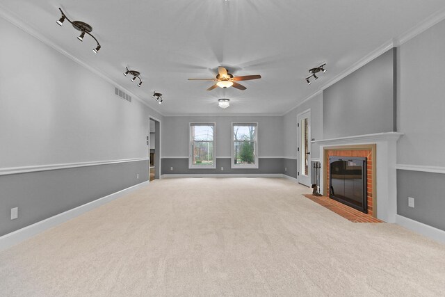 404 S Greenwood Ave, Columbia, MO 65203 - unfurnished living room with track lighting, crown molding, carpet, a fireplace, and a ceiling fan