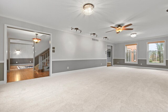 404 S Greenwood Ave, Columbia, MO 65203 - spare room with carpet, ornamental molding, stairs, ceiling fan, and baseboards