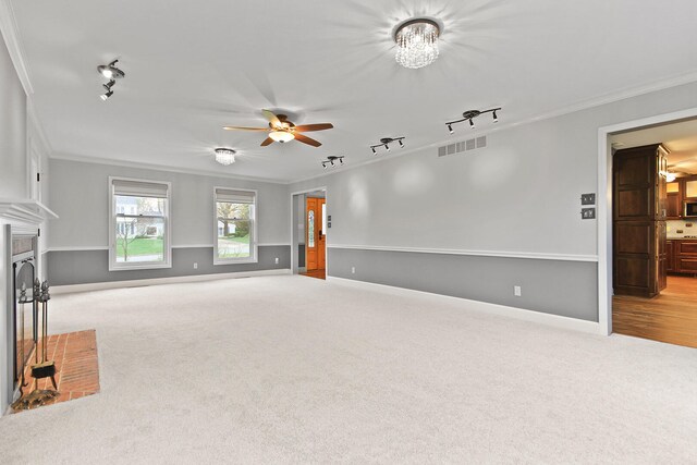 404 S Greenwood Ave, Columbia, MO 65203 - unfurnished living room with track lighting, crown molding, carpet, a ceiling fan, and baseboards