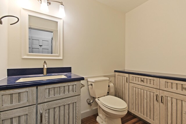 404 S Greenwood Ave, Columbia, MO 65203 - half bath featuring toilet, vanity, and wood finished floors