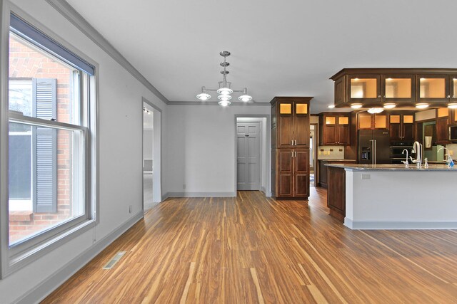 404 S Greenwood Ave, Columbia, MO 65203 - kitchen featuring high quality fridge, wood finished floors, baseboards, dark brown cabinets, and pendant lighting