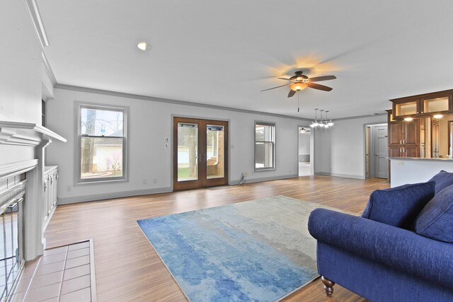 404 S Greenwood Ave, Columbia, MO 65203 - living room featuring a ceiling fan, ornamental molding, light wood-style floors, a fireplace, and baseboards