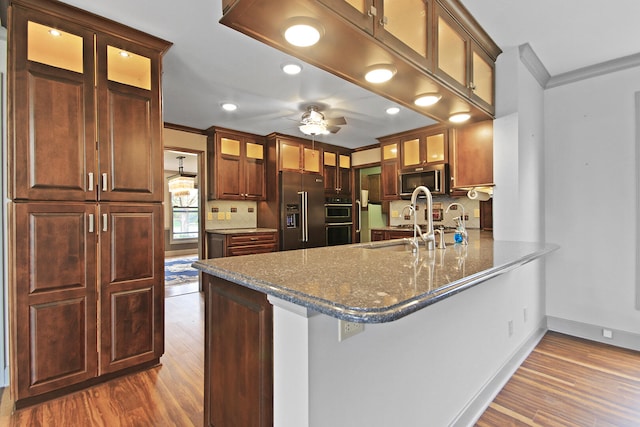 404 S Greenwood Ave, Columbia, MO 65203 - kitchen featuring stainless steel appliances, ornamental molding, dark wood-style floors, tasteful backsplash, and a sink