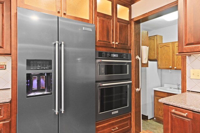 404 S Greenwood Ave, Columbia, MO 65203 - kitchen featuring high end refrigerator, a sink, tasteful backsplash, light countertops, and freestanding refrigerator