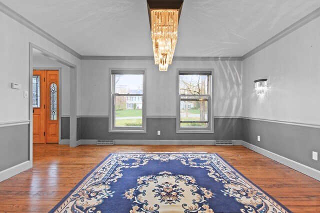 404 S Greenwood Ave, Columbia, MO 65203 - spare room featuring a chandelier, crown molding, hardwood / wood-style floors, and baseboards