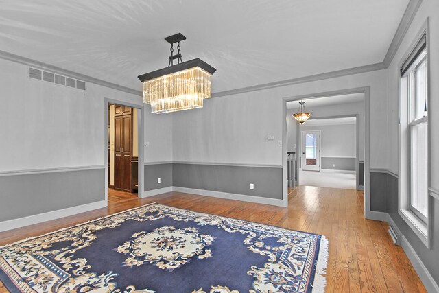 404 S Greenwood Ave, Columbia, MO 65203 - empty room with a chandelier, hardwood / wood-style floors, crown molding, and baseboards