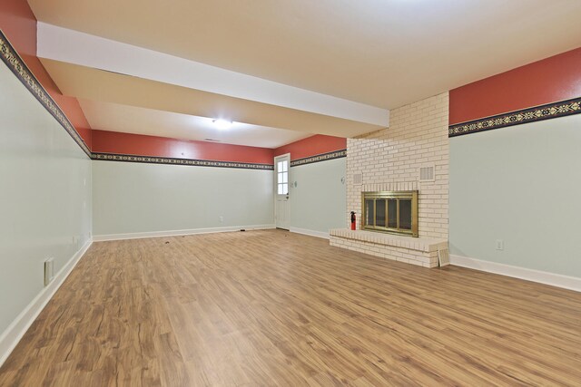 404 S Greenwood Ave, Columbia, MO 65203 - unfurnished living room with wood finished floors, a fireplace, and baseboards