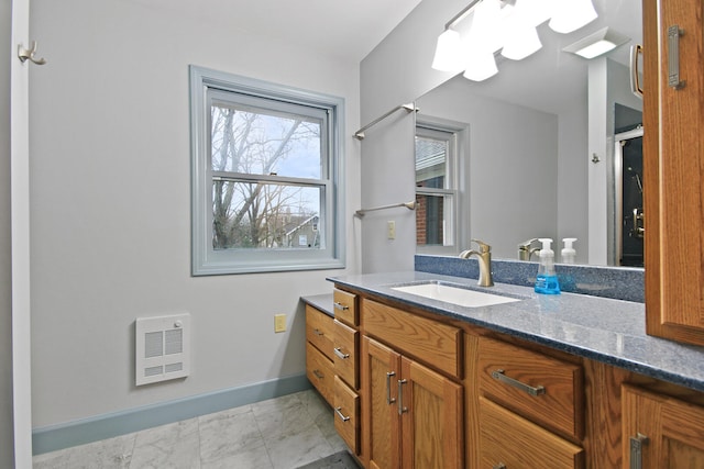 404 S Greenwood Ave, Columbia, MO 65203 - bathroom featuring heating unit, vanity, marble finish floors, and baseboards