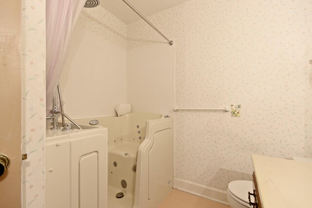 404 S Greenwood Ave, Columbia, MO 65203 - full bathroom featuring toilet, wallpapered walls, a combined bath / shower with jetted tub, vanity, and baseboards
