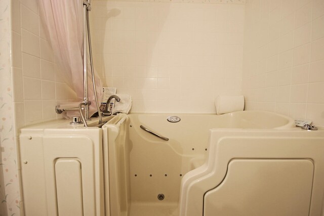 404 S Greenwood Ave, Columbia, MO 65203 - bathroom with tile walls and a jetted tub
