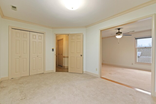 404 S Greenwood Ave, Columbia, MO 65203 - unfurnished bedroom featuring crown molding, carpet, a closet, baseboards, and a ceiling fan