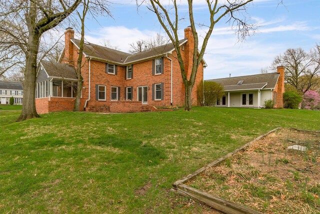 404 S Greenwood Ave, Columbia, MO 65203 - back of property with french doors, a chimney, a sunroom, brick siding, and a yard