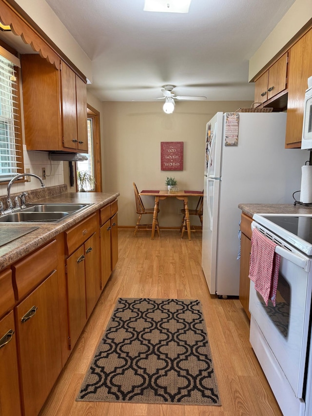 1609 Doris Dr, Columbia, MO 65202 - kitchen with white appliances, a sink, light wood-style floors, and plenty of natural light