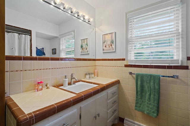 368 Crown Pt, Columbia, MO 65203 - bathroom featuring vanity, a wainscoted wall, and tile walls